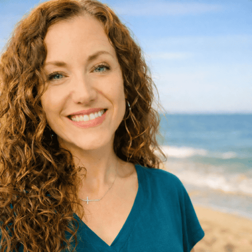 Elizabeth Rhyno smiling on the beach, founder of Joy Let Loose.